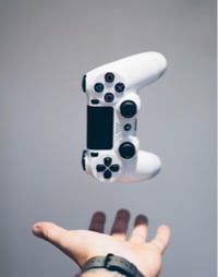 White ps4 controller with hand under